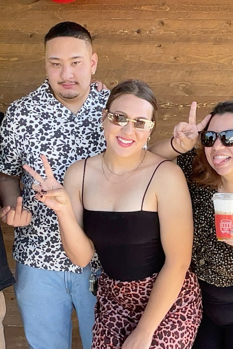Guests at an outdoor grand opening photo booth