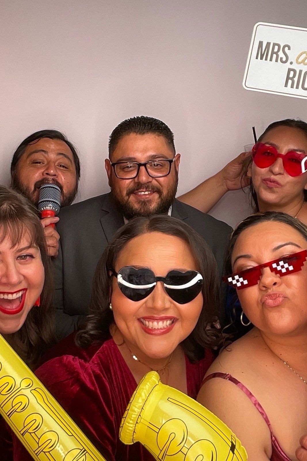 Wedding guests celebrating in front of the PBLA Booth backdrop