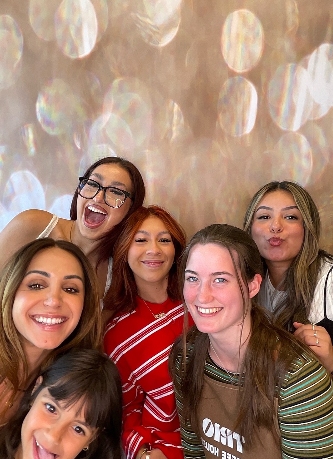 Friends smiling at a casual event photo booth session
