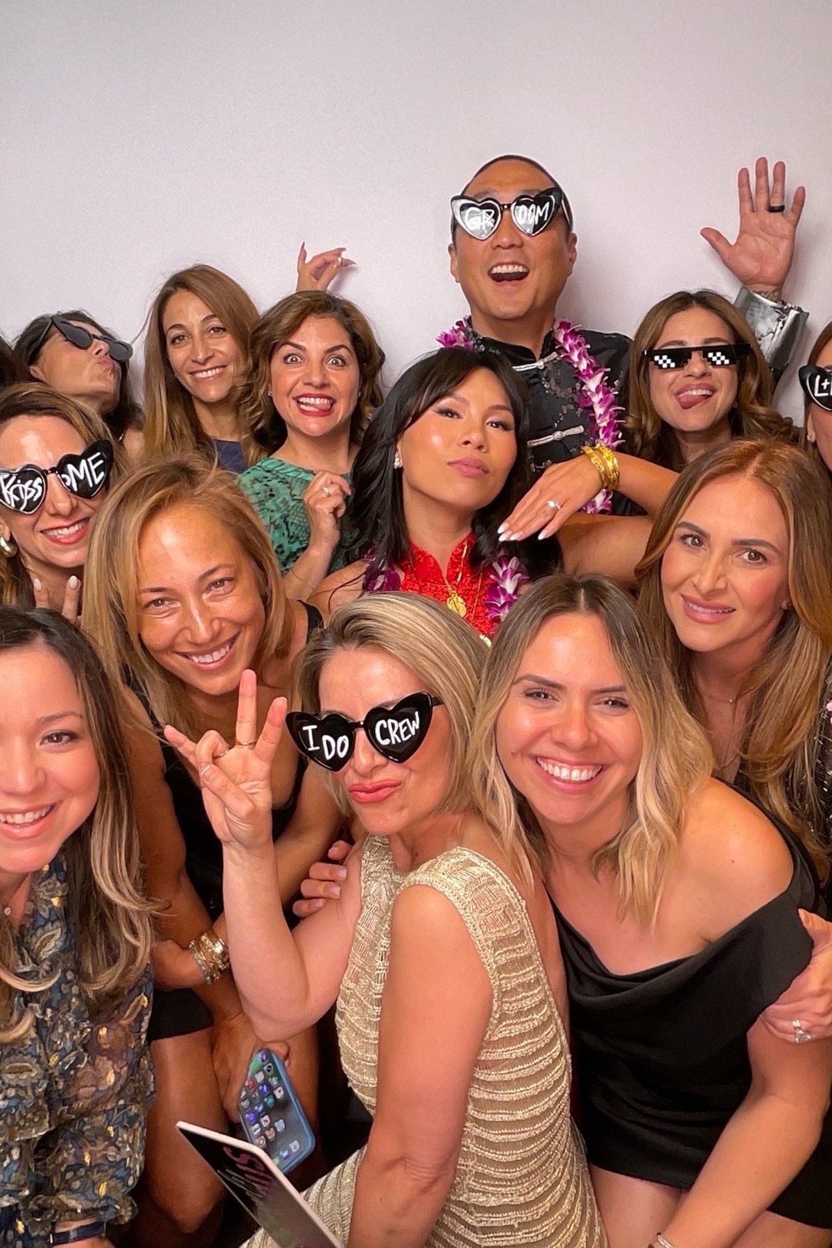 Wedding guests celebrating in front of the PBLA Booth backdrop